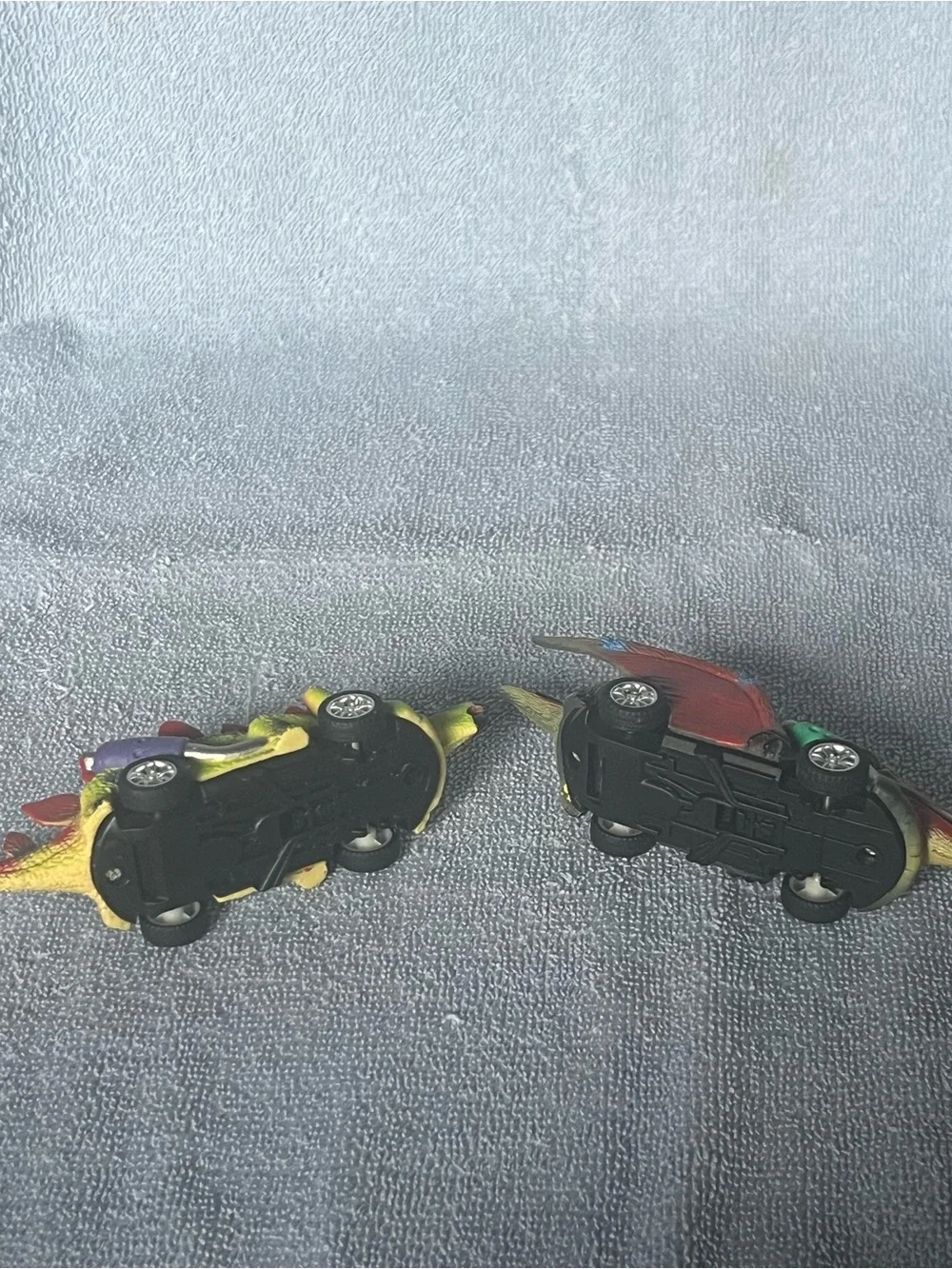 Two dinosaur pull-back toy cars